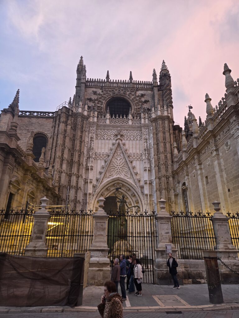 the exterior of Seville Cathedral (Catedral de Sevilla), the main Gothic façade by the Giralda.